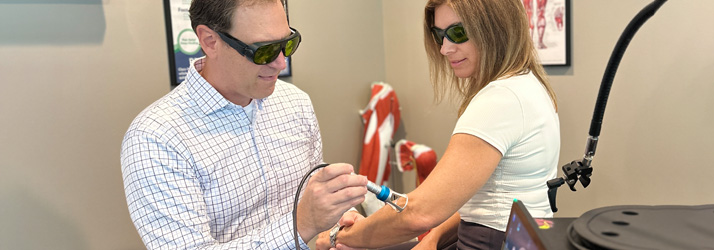 Chiropractor LaPorte IN Matthew Kirkham With Laser Therapy Patient