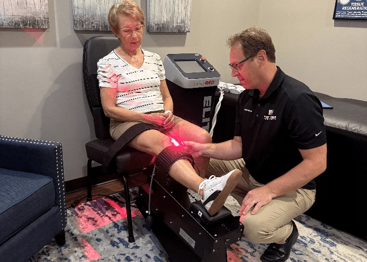 Matthew Kirkham Using Shockwave Therapy on Patient's Knee