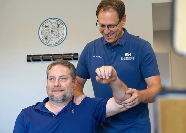 Matthew Kirkham Examining Male Patient to Access Shoulder Function