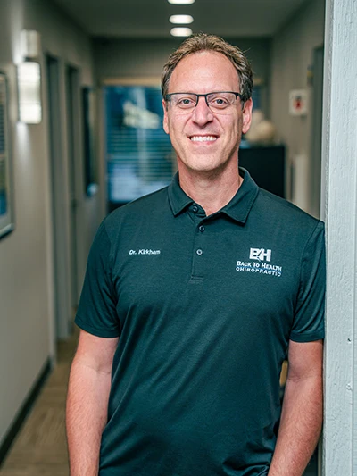 Matthew Kirkham Standing In Hallway Leaning Against Doorframe